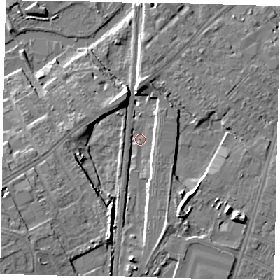 Shaded relief map of the ground around MK429DT, computed from Environment Agency LiDAR. The ground here sits at about 27 m above sea level and falls 11 m across the surrounding 800 m. Surface water reaching this point runs off ground lying to the south, 6.6 m higher.