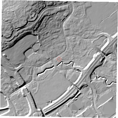 Shaded relief map of the ground around MK77BB, computed from Environment Agency LiDAR. The ground here sits at about 68 m above sea level and falls 21 m across the surrounding 800 m. Surface water reaching this point runs off ground lying to the north-east, 6.5 m higher.
