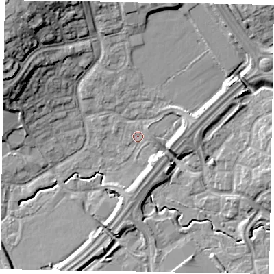Shaded relief map of the ground around MK77BN, computed from Environment Agency LiDAR. The ground here sits at about 69 m above sea level and falls 19 m across the surrounding 800 m. Surface water reaching this point runs off ground lying to the east, 0.5 m higher.