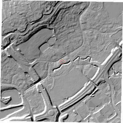 Shaded relief map of the ground around MK77BX, computed from Environment Agency LiDAR. The ground here sits at about 68 m above sea level and falls 21 m across the surrounding 800 m. Surface water reaching this point runs off ground lying to the north-north-west, 18.0 m higher.