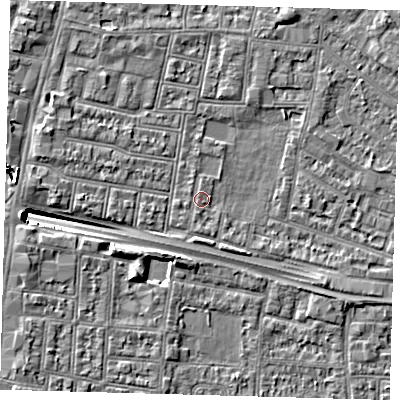 Shaded relief map of the ground around N182EQ, computed from Environment Agency LiDAR. The ground here sits at about 12 m above sea level and falls 9 m across the surrounding 800 m. Surface water reaching this point runs off ground lying to the south, 1.0 m higher.