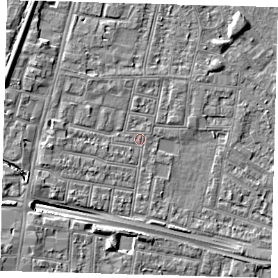 Shaded relief map of the ground around N182QS, computed from Environment Agency LiDAR. The ground here sits at about 12 m above sea level and falls 13 m across the surrounding 800 m. Surface water reaching this point runs off ground lying to the west-north-west, 6.2 m higher.