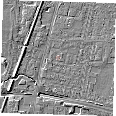 Shaded relief map of the ground around N182QX, computed from Environment Agency LiDAR. The ground here sits at about 13 m above sea level and falls 13 m across the surrounding 800 m. Surface water reaching this point runs off ground lying to the west-north-west, 5.9 m higher.