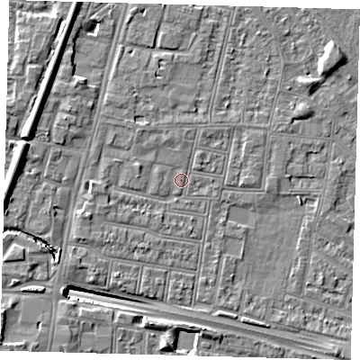 Shaded relief map of the ground around N182QZ, computed from Environment Agency LiDAR. The ground here sits at about 12 m above sea level and falls 13 m across the surrounding 800 m. Surface water reaching this point runs off ground lying to the west-north-west, 1.5 m higher.