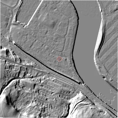 Shaded relief map of the ground around NE214FN, computed from Environment Agency LiDAR. The ground here sits at about 5 m above sea level and falls 52 m across the surrounding 800 m. Surface water reaching this point runs off ground lying to the south-south-east, 5.3 m higher.