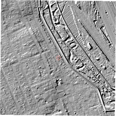 Shaded relief map of the ground around NG104JA, computed from Environment Agency LiDAR. The ground here sits at about 33 m above sea level and falls 7 m across the surrounding 800 m. Surface water reaching this point runs off ground lying to the west, 4.4 m higher.