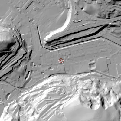 Shaded relief map of the ground around OL145DE, computed from Environment Agency LiDAR. The ground here sits at about 124 m above sea level and falls 91 m across the surrounding 800 m. Surface water reaching this point runs off ground lying to the west, 19.6 m higher.