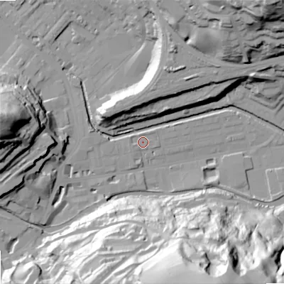 Shaded relief map of the ground around OL145DG, computed from Environment Agency LiDAR. The ground here sits at about 124 m above sea level and falls 85 m across the surrounding 800 m. Surface water reaching this point runs off ground lying to the west-north-west, 1.6 m higher.