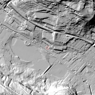 Shaded relief map of the ground around OL145JT, computed from Environment Agency LiDAR. The ground here sits at about 128 m above sea level and falls 122 m across the surrounding 800 m. Surface water reaching this point runs off ground lying to the south-west, 119.2 m higher.
