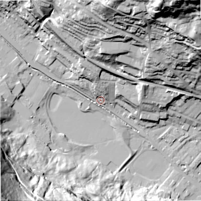 Shaded relief map of the ground around OL145LB, computed from Environment Agency LiDAR. The ground here sits at about 130 m above sea level and falls 133 m across the surrounding 800 m. Surface water reaching this point runs off ground lying to the north, 16.7 m higher.