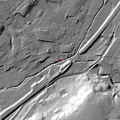 Shaded relief map of the ground around OL158DE, computed from Environment Agency LiDAR. The ground here sits at about 143 m above sea level and falls 67 m across the surrounding 800 m. Surface water reaching this point runs off ground lying to the south-south-east, 64.3 m higher.