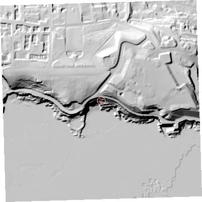 Shaded relief map of the ground around PL12JU, computed from Environment Agency LiDAR. The ground here sits at about 14 m above sea level and falls 38 m across the surrounding 800 m. Surface water reaching this point runs off ground lying to the north-east, 33.0 m higher.