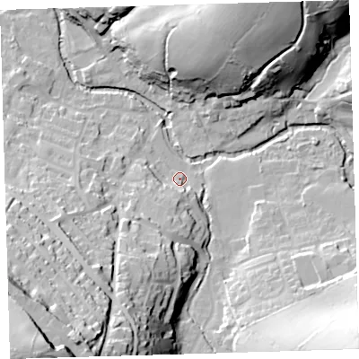 Shaded relief map of the ground around PL207TG, computed from Environment Agency LiDAR. The ground here sits at about 86 m above sea level and falls 73 m across the surrounding 800 m. Surface water reaching this point runs off ground lying to the south-south-west, 29.7 m higher.