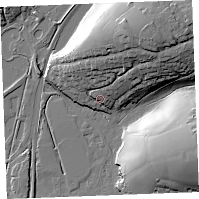 Shaded relief map of the ground around PL242PH, computed from Environment Agency LiDAR. The ground here sits at about 12 m above sea level and falls 43 m across the surrounding 800 m. Surface water reaching this point runs off ground lying to the north-north-east, 31.6 m higher.