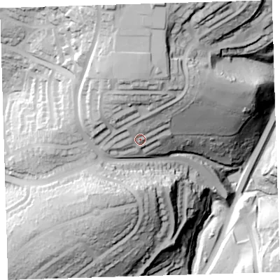 Shaded relief map of the ground around PL52AT, computed from Environment Agency LiDAR. The ground here sits at about 57 m above sea level and falls 83 m across the surrounding 800 m. Surface water reaching this point runs off ground lying to the north-north-west, 24.1 m higher.