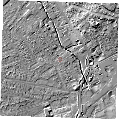 Shaded relief map of the ground around RM77DR, computed from Environment Agency LiDAR. The ground here sits at about 15 m above sea level and falls 18 m across the surrounding 800 m. Surface water reaching this point runs off ground lying to the west-north-west, 5.2 m higher.