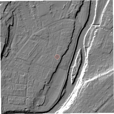 Shaded relief map of the ground around SY12TT, computed from Environment Agency LiDAR. The ground here sits at about 52 m above sea level and falls 17 m across the surrounding 800 m. The ground contributing surface water to this point lies to the east-north-east.