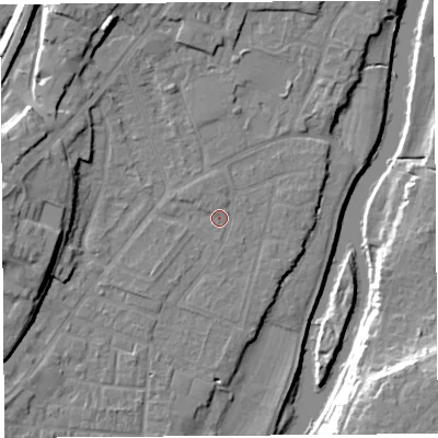 Shaded relief map of the ground around SY12TZ, computed from Environment Agency LiDAR. The ground here sits at about 52 m above sea level and falls 16 m across the surrounding 800 m. Surface water reaching this point runs off ground lying to the west, 9.9 m higher.