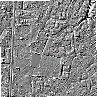 Shaded relief map of the ground around TA64DG, computed from Environment Agency LiDAR. The ground here sits at about 6 m above sea level and falls 3 m across the surrounding 800 m. Surface water reaching this point runs off ground lying to the north, 1.2 m higher.