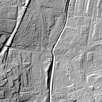 Shaded relief map of the ground around WS100DX, computed from Environment Agency LiDAR. The ground here sits at about 115 m above sea level and falls 18 m across the surrounding 800 m. Surface water reaching this point runs off ground lying to the west-south-west, 17.0 m higher.