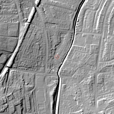 Shaded relief map of the ground around WS100RX, computed from Environment Agency LiDAR. The ground here sits at about 115 m above sea level and falls 18 m across the surrounding 800 m. Surface water reaching this point runs off ground lying to the west, 2.1 m higher.